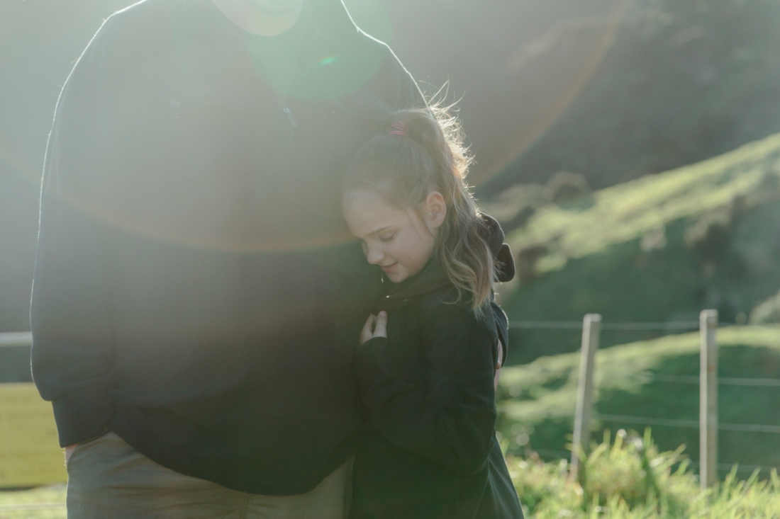 Farmer hugging daughter
