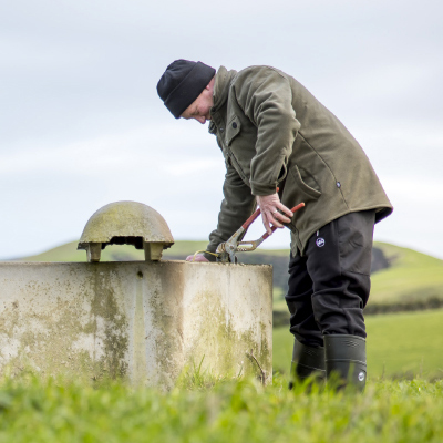 Farmer maintaining water trough