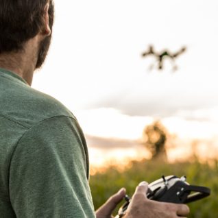 Man flying drone outside