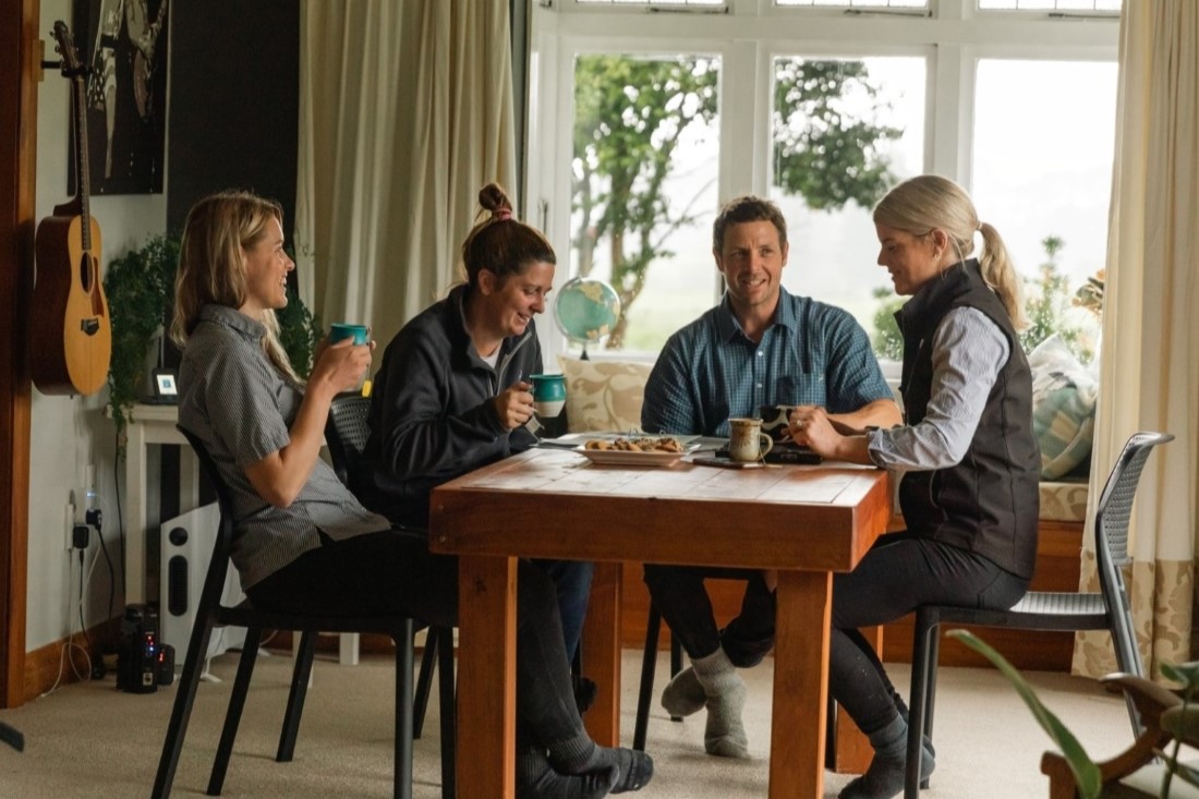 Farmers talking and eating at table