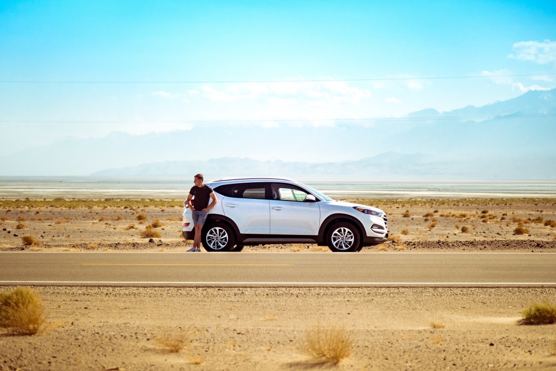 Man standing by Mazda vehicle