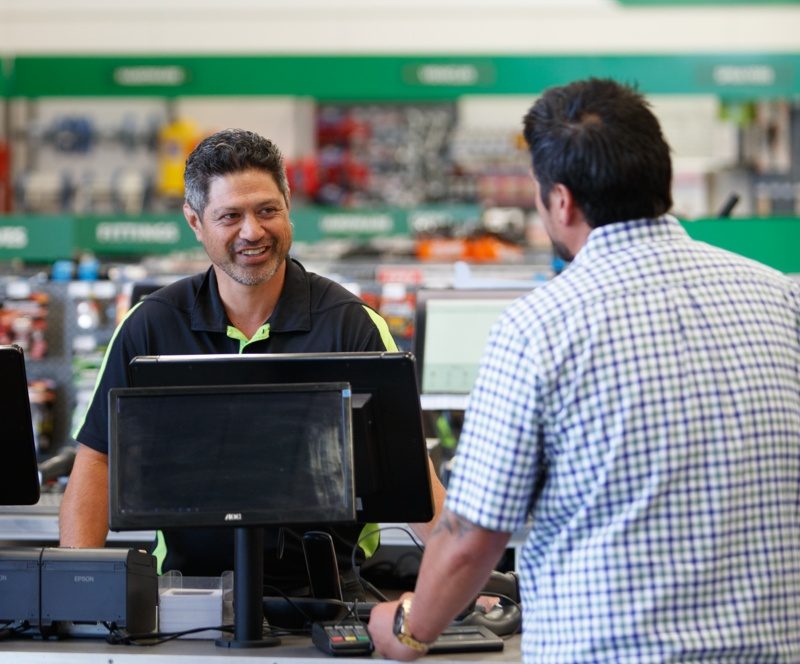 Farm Source employee with customer in store