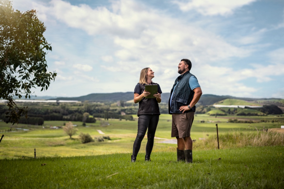 Farm Source staff member and farmer in paddock